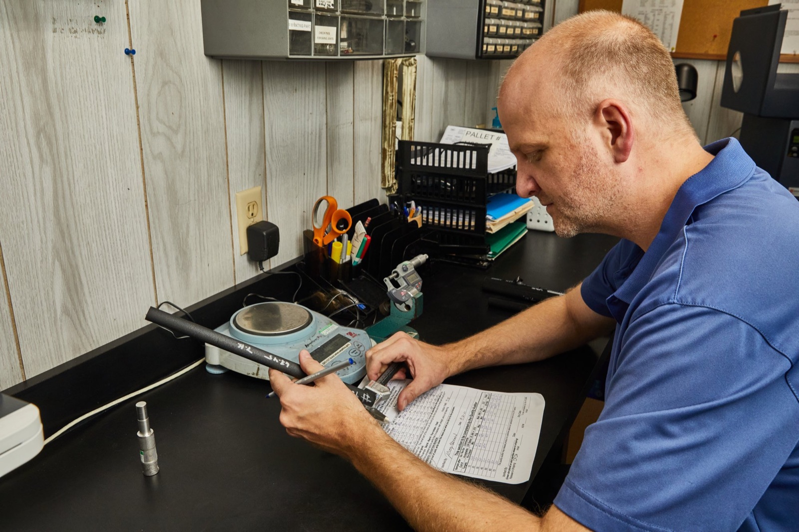Quality technician measuring a finished part